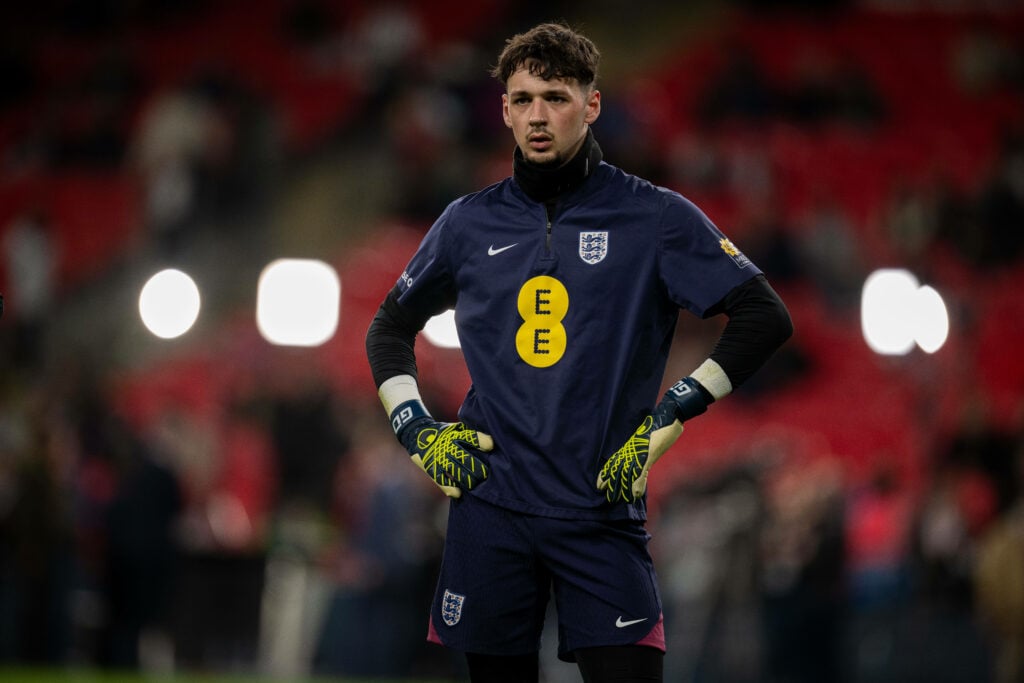 Manchester City goalkeeper James Trafford stands with his hands on his hips while warming up for England.