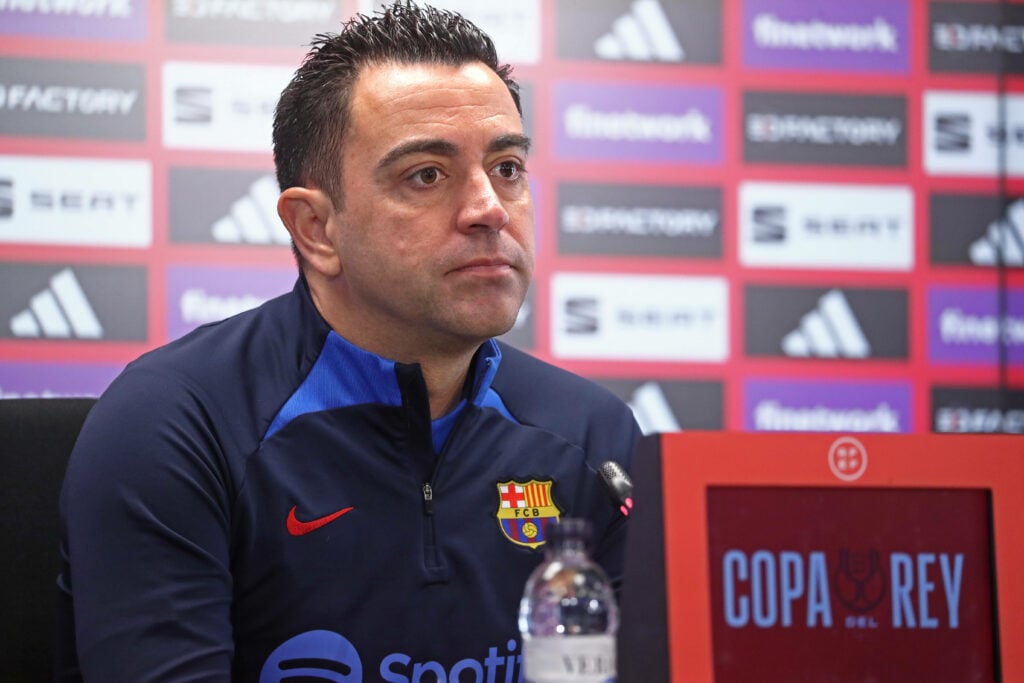 Former Barcelona manager Xavi sits in a press conference.