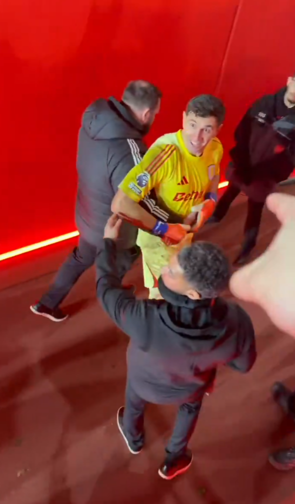 Aston Villa goalkeeper Emi Martinez is carried away by staff after a game vs Arsenal