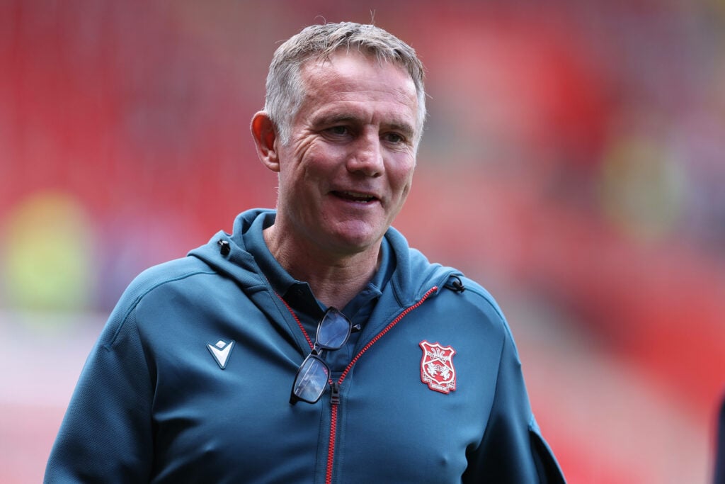 Phil Parkinson smiling in a Wrexham jacket