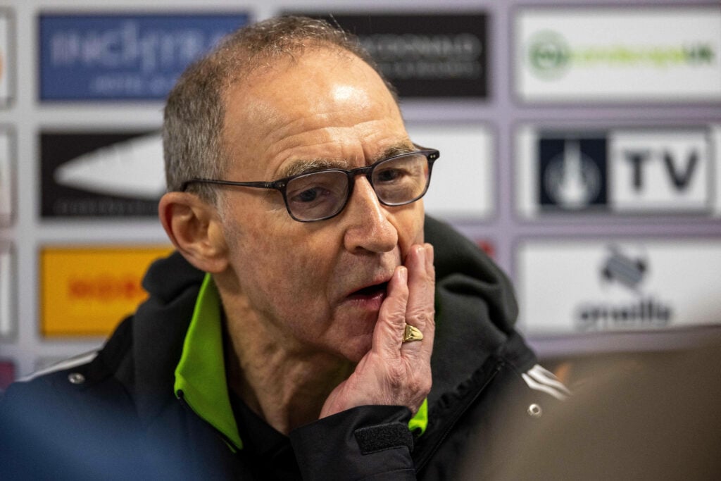 Celtic manager Martin O'Neill scratches his face during a press conference.