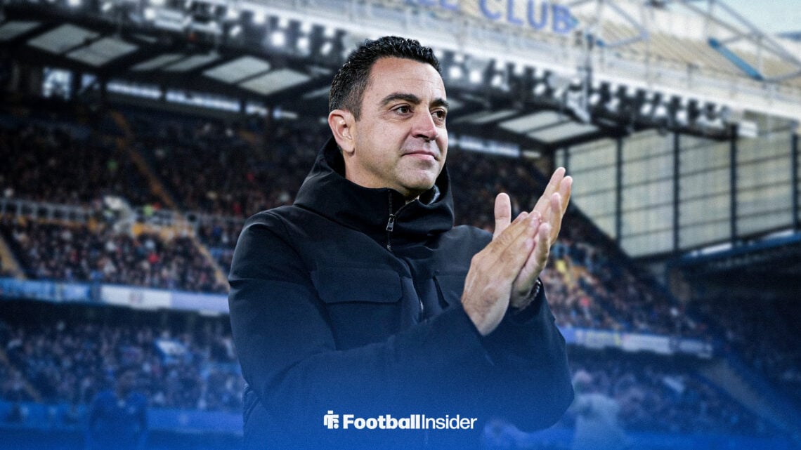 Xavi applauds while standing at Stamford Bridge.