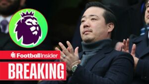 Leicester City owner Aiyawatt Srivaddhanaprabha applauds in the stands as the Premier League logo features in a circular inset.