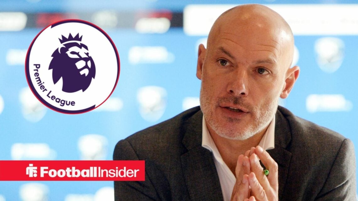 Howard Webb in a press conference, Premier League badge in a circular inset