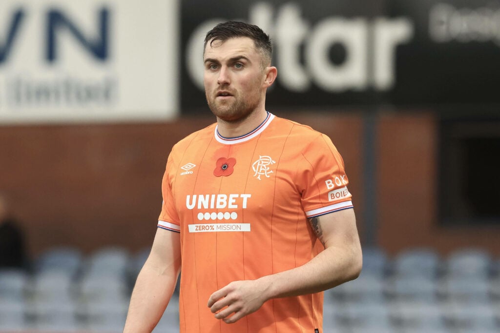 Rangers defender John Souttar in action wearing the club's 2025-26 orange away shirt.