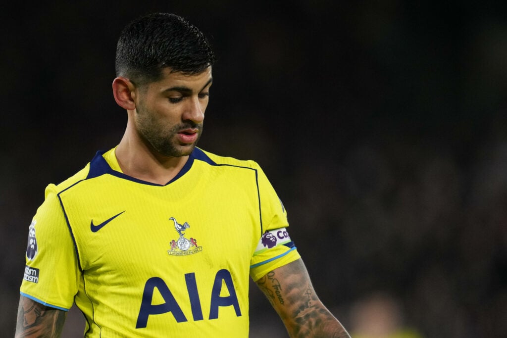 Tottenham defender Cristian Romero stares at the ground during a game.