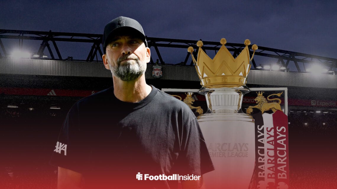 Former Liverpool manager Jurgen Klopp stands in front of Anfield with a Premier League trophy
