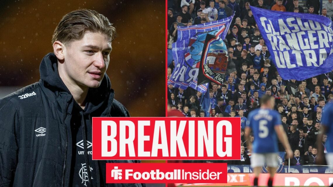 Rangers striker Ryan Naderi stands in the rain wearing a club jacket, as the fans wave flags in the stands at Ibrox on the other side of a split im...