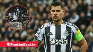 Newcastle captain Bruno Guimaraes stands with his hands on his hips during a game, as the fans wave flags in a circular inset.