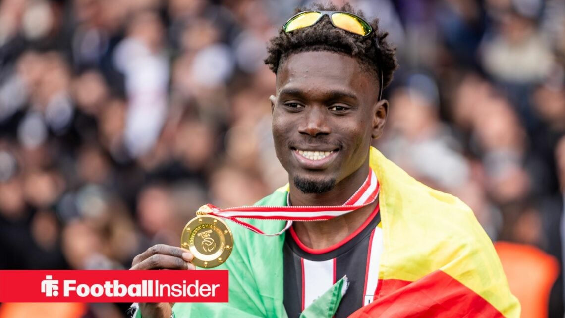 LASK defender Modou Keba Cisse holds up winners medal and smiles