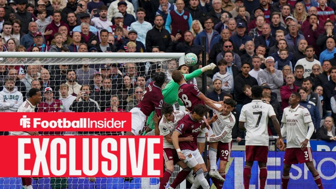 Arsenal goalkeeper David Raya attempts to punch a West Ham corner away in a crowded penalty area at the London Stadium.